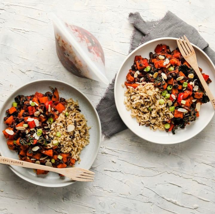 Stew and rice served on plates and stored nearby in a reusable pouch.